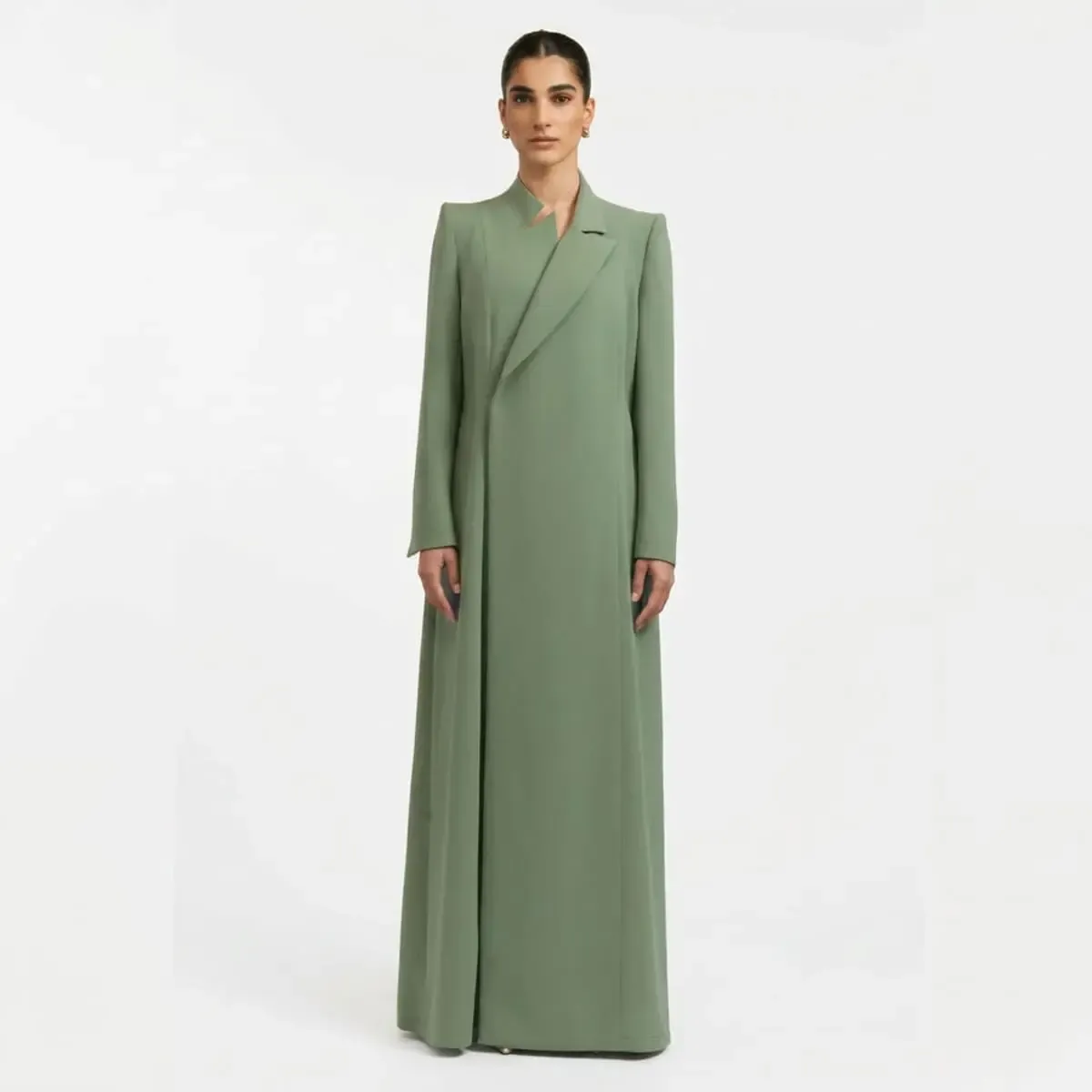 Luxury sage green tailored abaya featuring an asymmetric crossover lapel, structured shoulders, and a floor-length minimalist silhouette by LAYL.