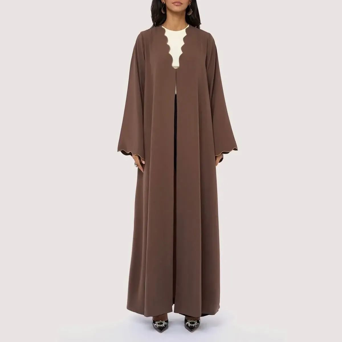 Luxury mocha brown open-front abaya with signature wave-edge neckline, sculpted sleeve cuffs, contrast piping, and a flowing minimalist silhouette by LAYL.